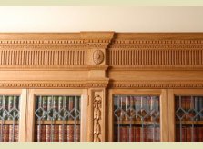 Detail of a heavily hand carved Oak bookcase